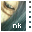 Pixelated image of a dog's face with light brown and white fur against dark green background, displaying 'nk' text at bottom.