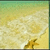 Pixelated static image of a beach scene with yellow sand, light blue water, and green sky transitioning to white clouds.