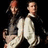 Red background with green pixelated text and a small image of two people in formal attire on the left side.
