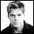 Black-and-white pixelated portrait of a person with styled hair and dark clothing against a white background, rendered in low-resolution grayscale with visible dithering and anti-aliased edges.