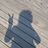 Two pixelated figures in blue striped clothing stand side-by-side against a light patterned background, one with obscured face and the other with visible black rectangular overlays.
