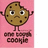 Pixelated cookie character with arms raised, standing on pink background beneath pixelated text.