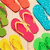 Pixelated flip-flop icons in red, blue, green, yellow, and orange arranged in a repeating pattern on a light background.
