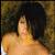 Static image shows a person with dark hair against textured background, next to green with pixelated text