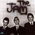 Three stylized figures in dark suits stand beneath large text reading 'The Jam' on a light gray background with pixelated rendering.