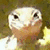 A split-screen image shows a pixelated reptile face on the left and text on the right, with the right side changing from green to blue background text.