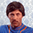 A pixelated image of a person with short dark hair wearing a blue shirt, next to red background with black text reading "i can chuck a pigs kin over them mountains".