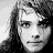A 48x48 pixel buddy icon featuring a contact sheet layout with two distinct portrait images and text, displayed on a gray background.