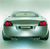 Static pixel art of a rear view of a light green car with red taillights and a visible license plate area.