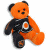 Pixelated orange teddy bear with black limbs wears a dark jersey featuring an orange and white circular emblem on chest, standing against white background.