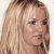 A static pixelated image of a person with long light brown hair, fair skin, and dark eyes, cropped to show the head and upper shoulders against a plain light background.