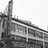 Black-and-white pixelated image of a building with vertical and horizontal lines forming a geometric structure.
