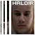 Pixelated static image of a person's face with the word HALDIR in white block letters at the top, set against a dark background with vertical gray and black bars on the left.