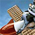 Pixelated image of a character in a white shirt and red pants holding a large brown object against a blue background.