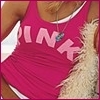 A person wearing a pink sleeveless top with large pink letters spelling 'PINK' across the chest, partially visible against a light background.