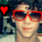 Pixelated image of a person wearing red-framed sunglasses with a bright red heart symbol in the top-left corner.