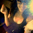 Pixelated image of a figure with dark hair and light skin, wearing a sleeveless top against a gradient background.