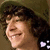 Pixelated image of a person with dark curly hair wearing a green cap, smiling with eyes closed, and pink text reading "Adam Sevan" in the top right corner.