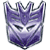 Pixelated purple and gray Transformers character face with sharp angular features, dark eye slits, and a stylized helmet-like top against white background.