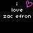 Pixelated text and a pink heart symbol on black background with repeated 'i love zac efron' text.