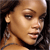 Pixelated close-up of a person with light brown skin tone, dark hair, and visible ear, wearing a dark strap over the shoulder.