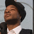 A four- shows a person in a black jacket and white shirt with a black beanie, displaying different expressions and text overlays