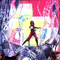 Animated sequence of a figure in red pants and black top performing dynamic poses against colorful abstract backgrounds with stage lights.