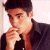 A pixelated image of a person in dark clothing with hand near mouth, next to green background with bright green text reading Original Icons .com.