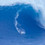 A blue ocean wave curls into a tunnel with white foam, containing a small surfer figure in the lower-left section of each frame.