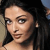 Pixelated close-up of a person with dark hair, light skin, and visible eyes and nose against a blurred background.