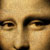 Pixelated close-up of a human face showing eyes, nose, and part of the forehead with warm brown and beige tones.