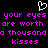 Pixelated text in bright pink on black background with white heart symbol above, repeating 'your eyes your eyes are worth a thousand kisses kisses' twice.