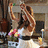 A pixelated image shows a woman in white dancing with raised arms, next to pink text reading "Shut Up And Dance" on the right.