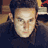 Static 48x48 pixel buddy icon showing a close-up of a person's face with dark hair and neutral expression against a blurred background.