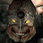 Pixelated static image of a stylized face with glowing yellow eyes, dark circular nose, and wide open mouth showing teeth.