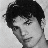 Black-and-white portrait of a person with dark curly hair on left, blue stylized text 'Jens Icons COM' on right against white background.