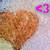 A heart-shaped brown object with a textured surface appears in a of six , each featuring a different colored outline of a <3 symbol