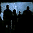 Silhouetted figures stand against a blue-gray background with icicle-like shapes, while bold red text reads "LAND OF THE DEAD" at the bottom.
