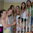 Group of people on stairs with changing text overlays in pink and black.