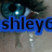 Pixelated image with blue banner displaying black text 'shley6' over blurred background featuring dark teal and brown shapes.