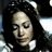 A woman with long dark hair and a white collar appears in three showing subtle head and eye position changes