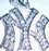Pixelated blue and white stylized letter M with curved serifs on a light background.
