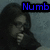 Pixelated image of a person with long dark hair and a light-colored shirt, with blue text reading 'Numb' in the top-right corner.