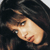 Pixelated close-up of a person's face with dark hair against a black background, showing partial facial features and skin tones in low-resolution style.