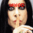 A person with long dark hair holds a finger to their lips in a shushing gesture, with red pixelated text above their head.