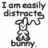 Pixelated grayscale image shows a cartoon bunny with raised arms and text above reading 'I am easily distracted' and below reading 'BUNNY.'