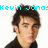 A pixelated image of a person with dark hair in three , accompanied by cyan text reading "Kevin Jonas: is bringin' sexy back!" on a white background