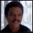 identical static images showing a person with dark hair and mustache wearing black shirt against light background