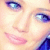 A close-up of a person's face showing eyes, nose, and mouth with pink lips against light skin tones.