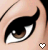 A close-up of a stylized cartoon eye with winged eyeliner, brown iris, and white sclera. A small pixelated heart icon appears below the eye in different colors across frames.